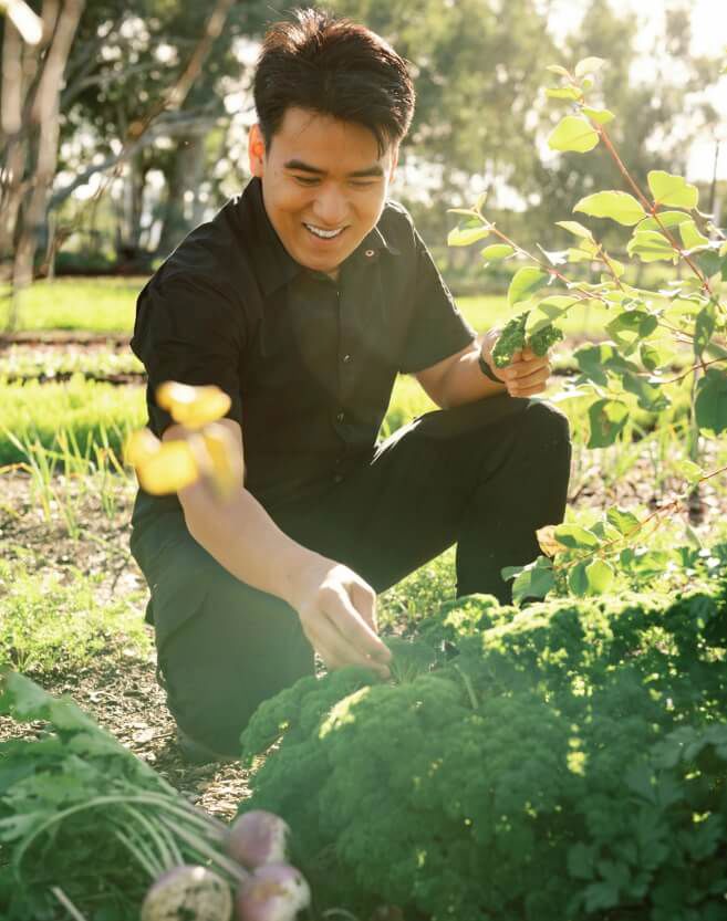 Head chef Fendi Bong picking fresh produce to use in the kitchen